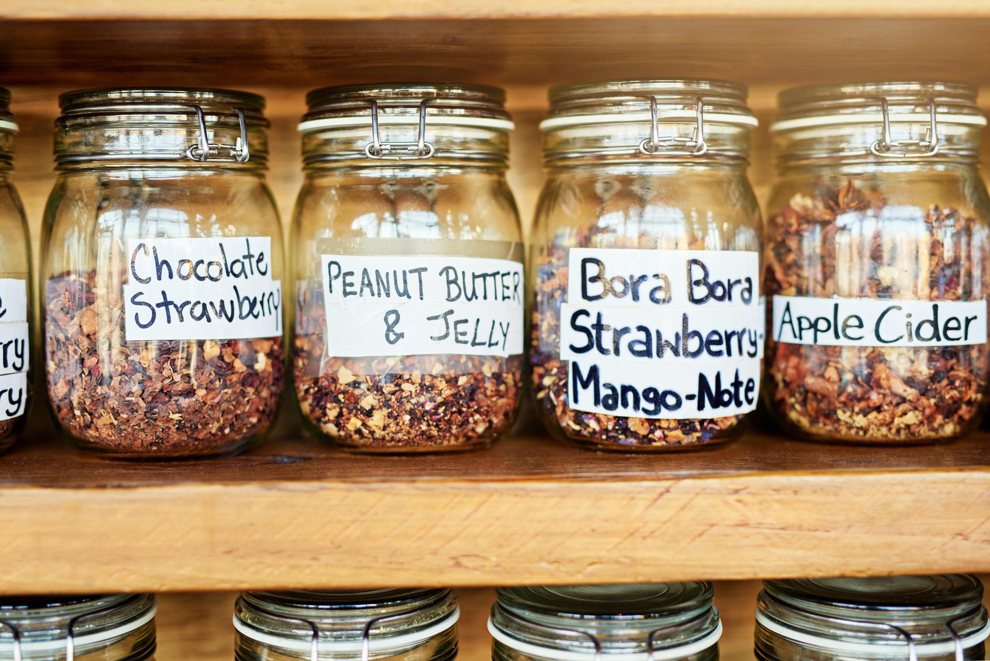 A neat stack of preserved jars labeled and lined on shelf